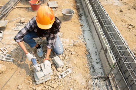 Round saw in the hands of the Builder, work on laying paving slabs. Working saws, cuts paving slab